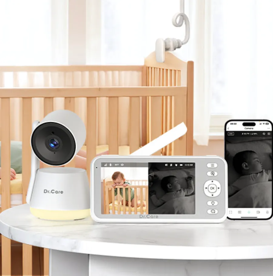Dr. Care baby camera and monitor shown beside a crib with phone app preview