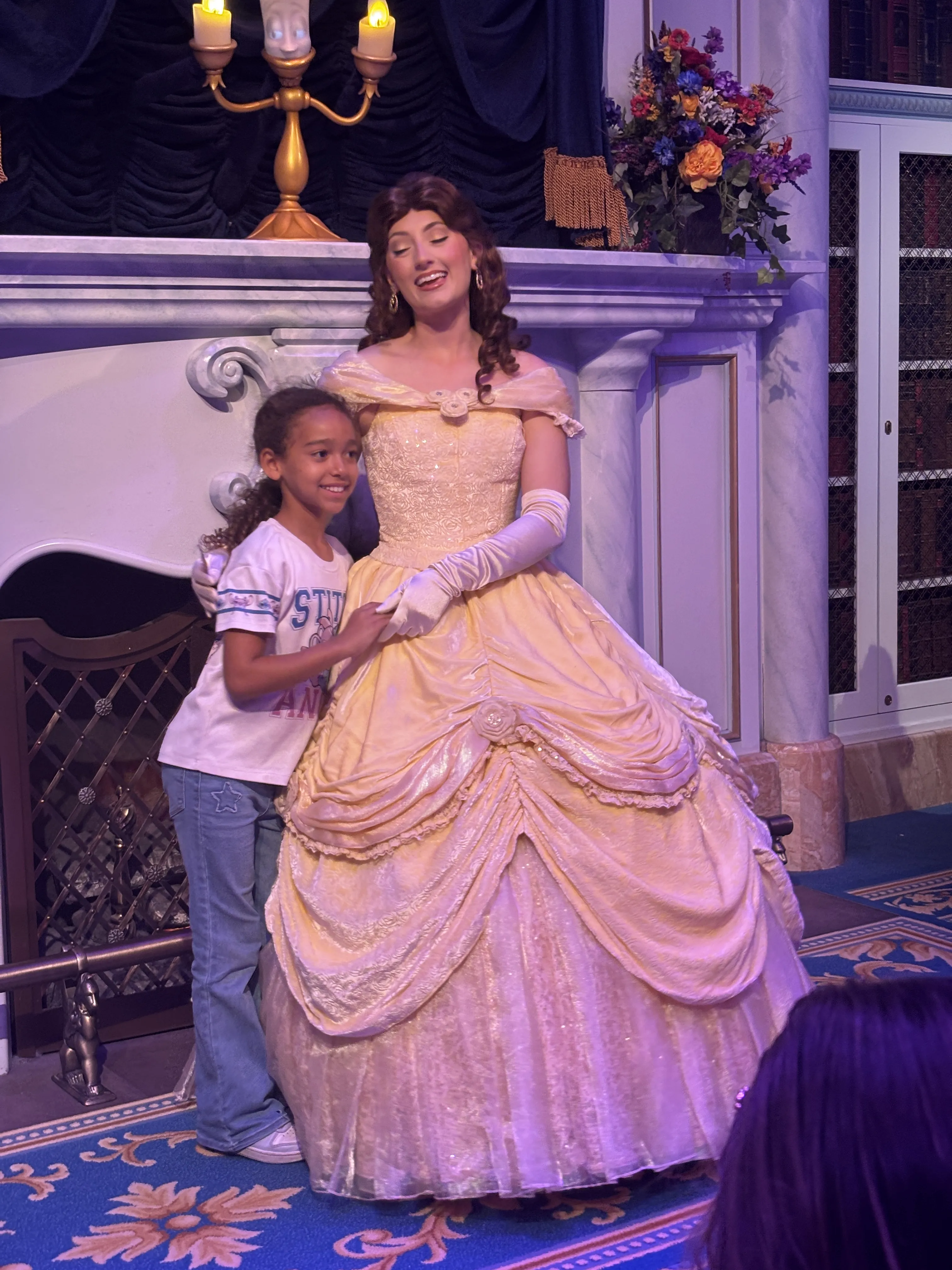 Niabelle smiling with Belle during the Beauty and the Beast experience at Magic Kingdom