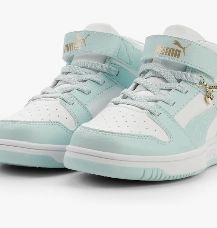 Mint and white Puma sneakers with gold accents and charm chain